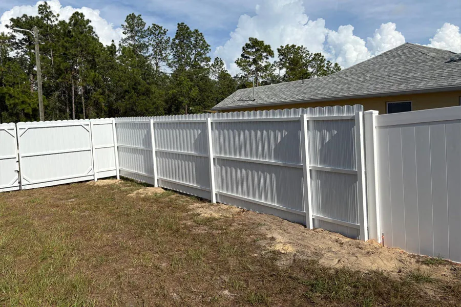 White PVC corner fence in a residential backyard