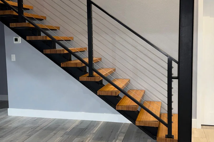 Black metal railing along a modern indoor staircase