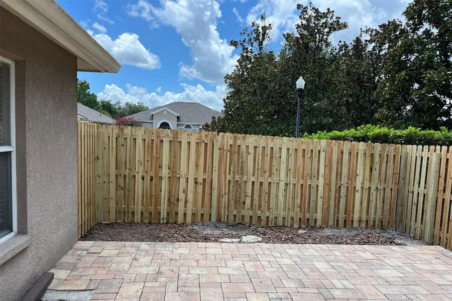 Completed wood privacy fence beside a residential patio