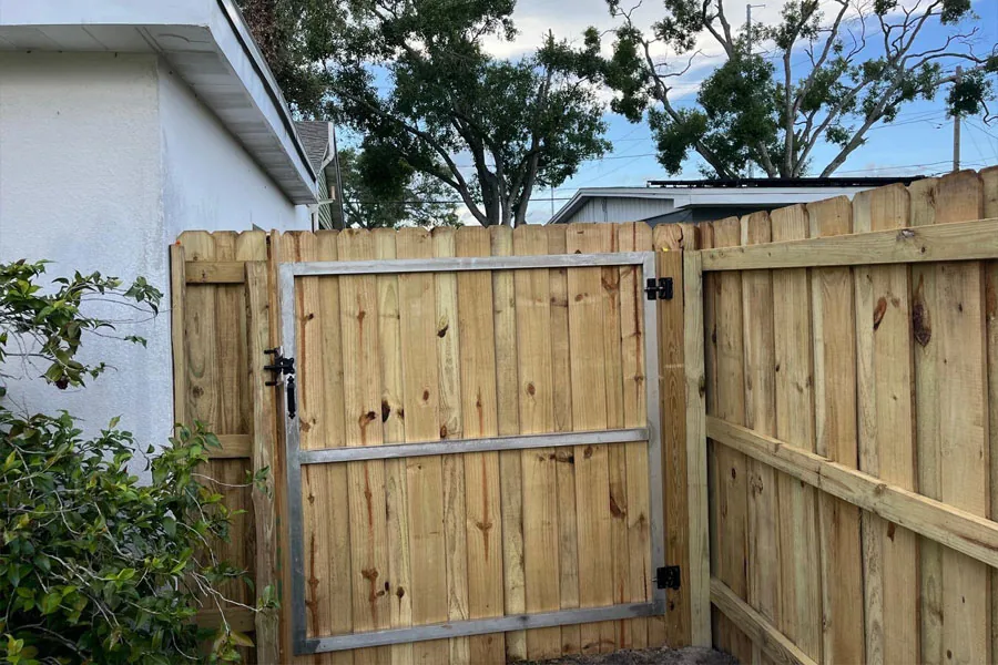 Custom wood access gate in a privacy fence