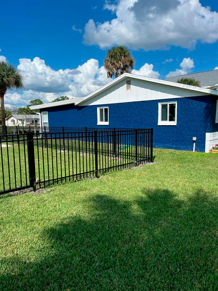 Black aluminum fence at a landscaped yard