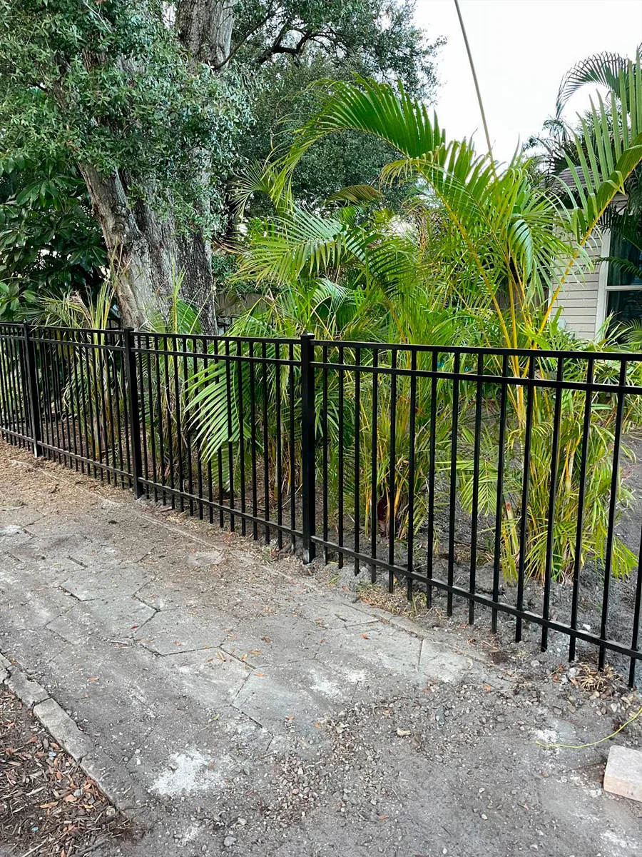Black aluminum perimeter fence at a home
