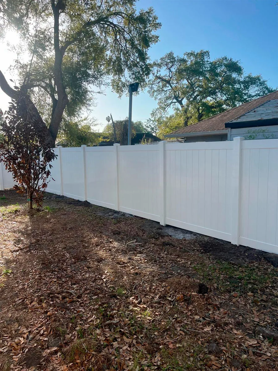 White PVC privacy fence along a residential yard