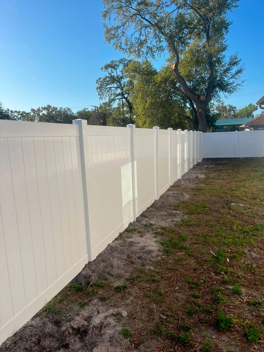 Long white PVC privacy fence at a property