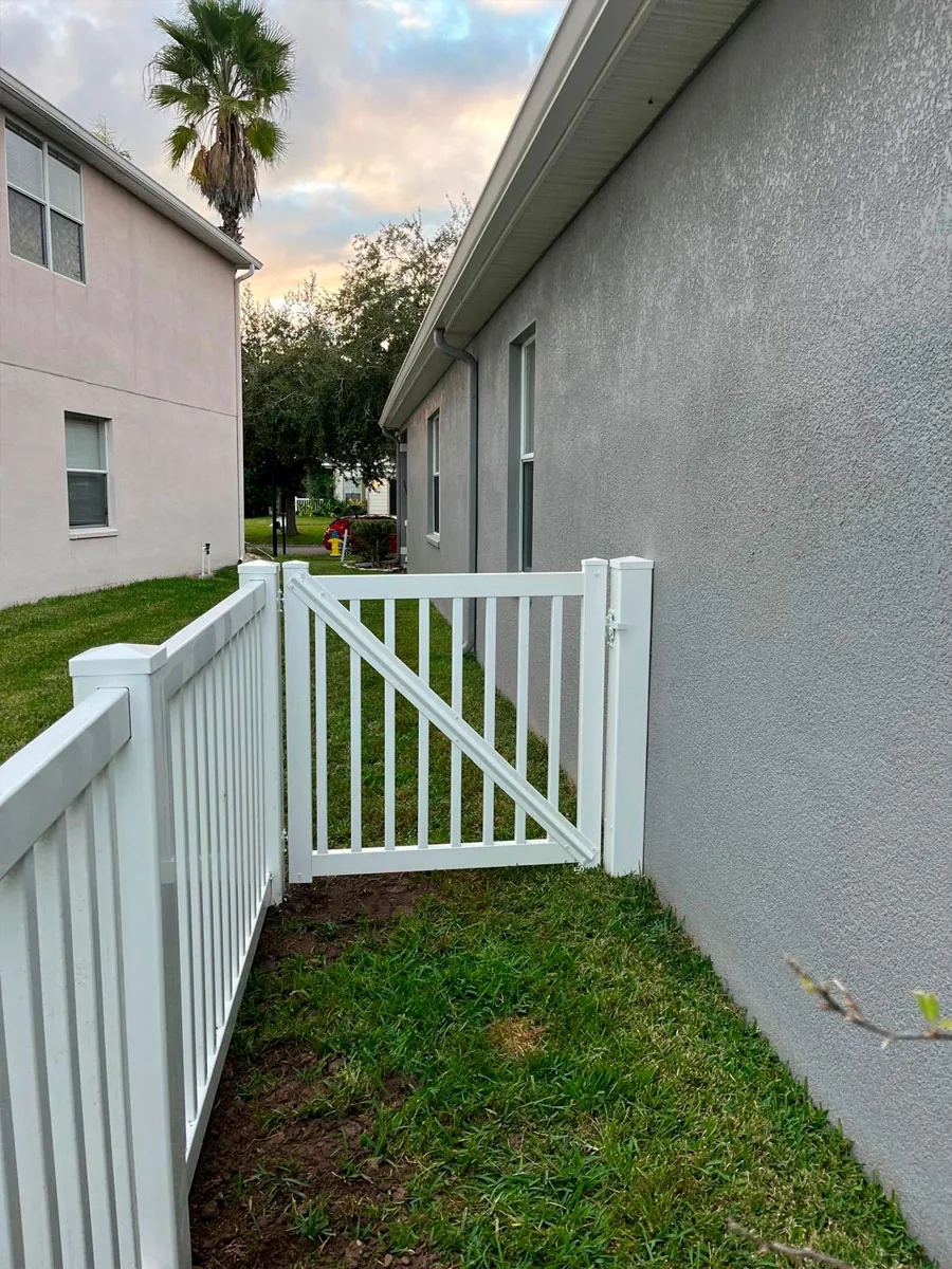 White PVC gate at a side yard