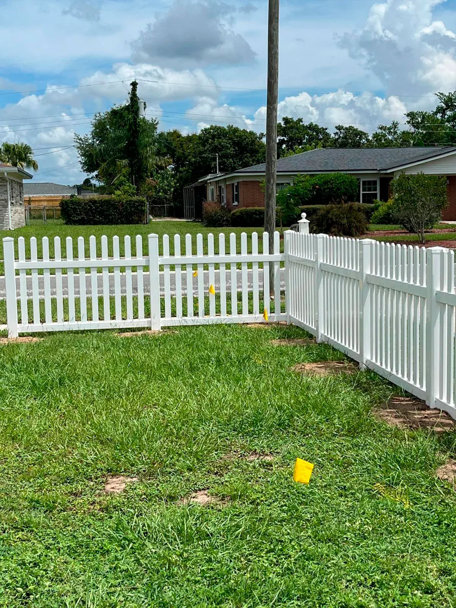 White PVC picket fence around a yard