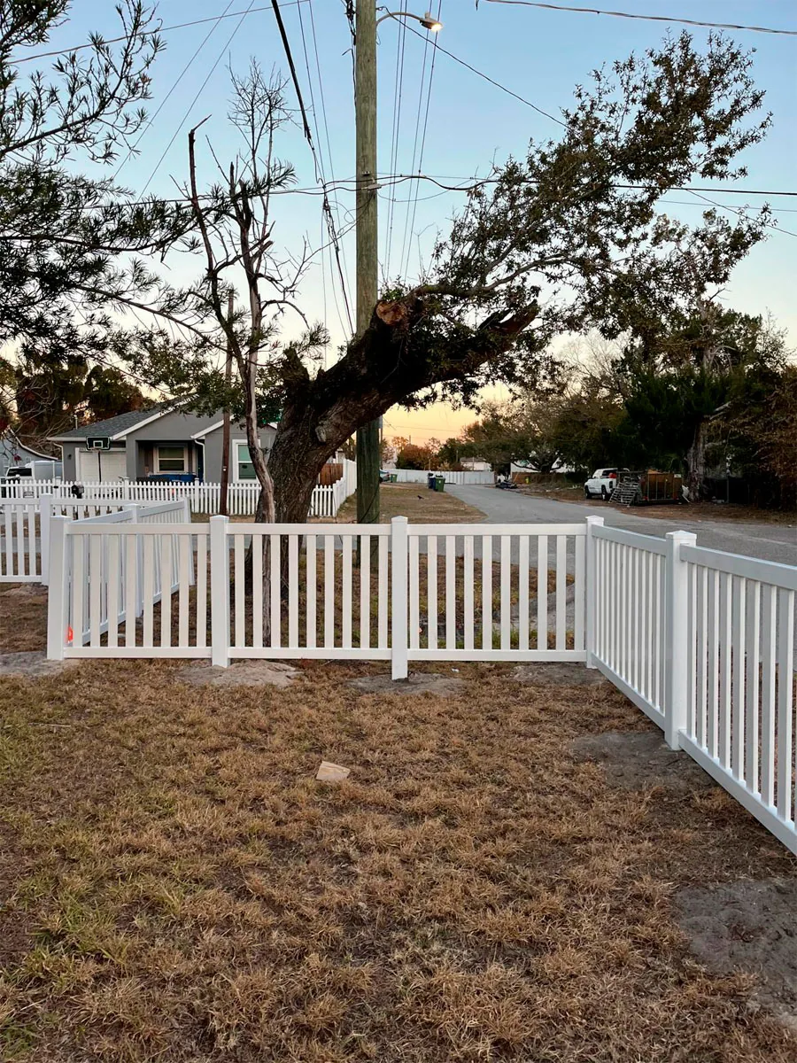 White PVC picket fence across a property