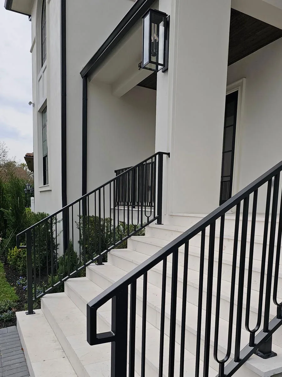 Black metal railings at a front entry