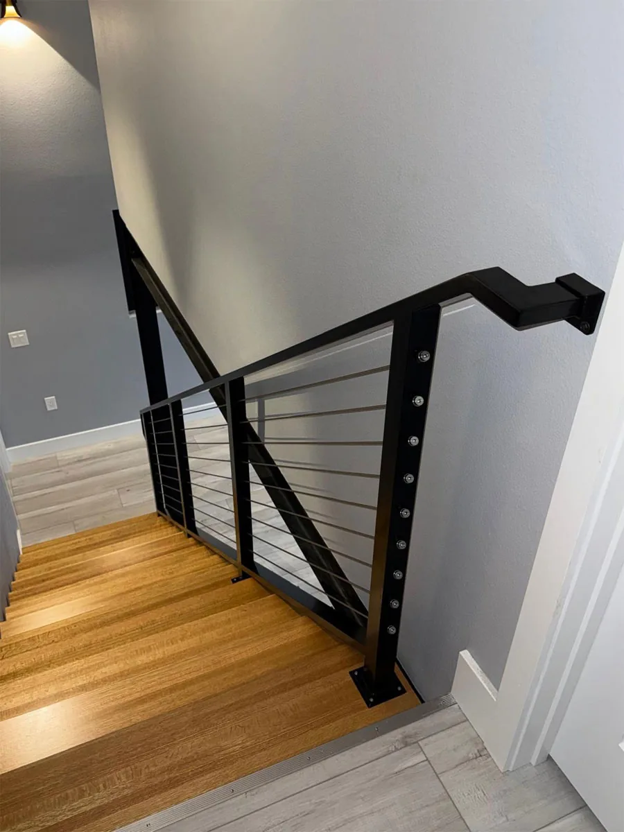Black metal railing along an indoor staircase