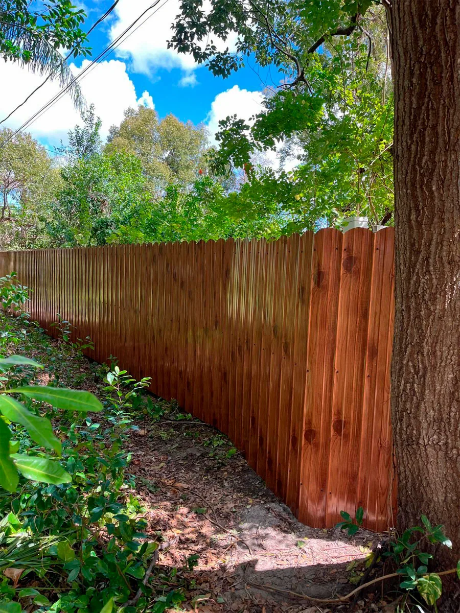 Long wood fence along a landscaped property