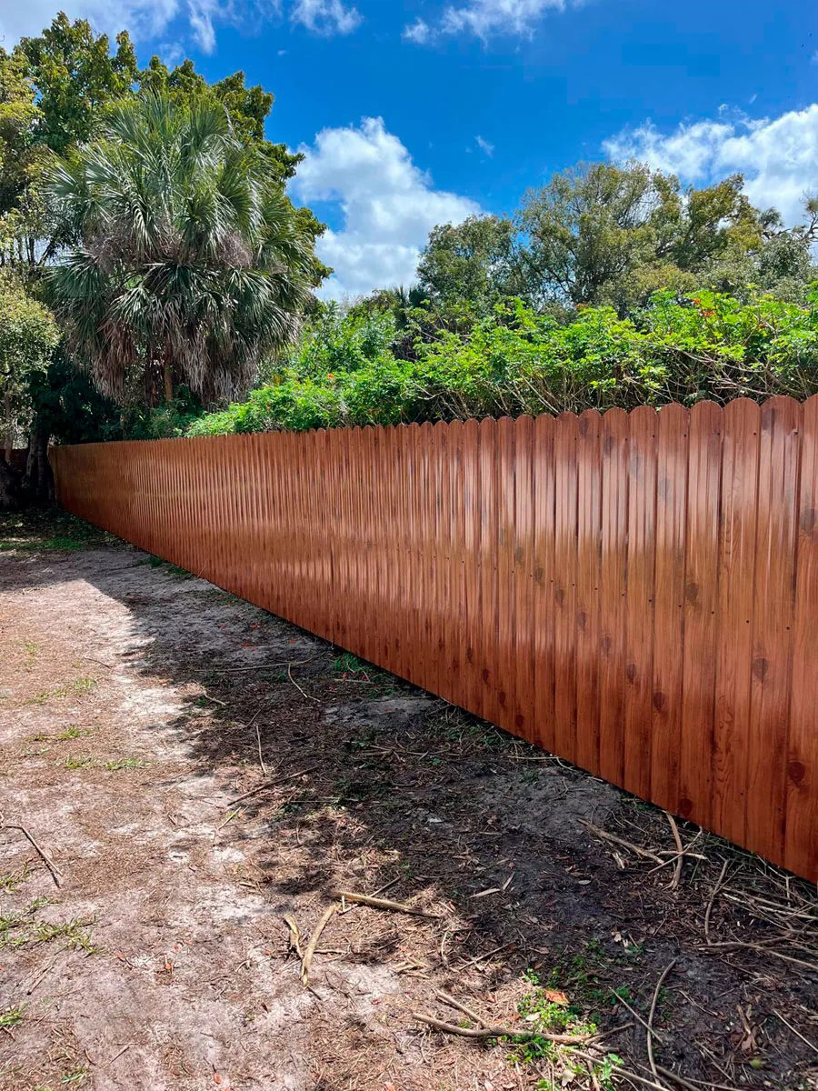 Natural wood fence along a side yard