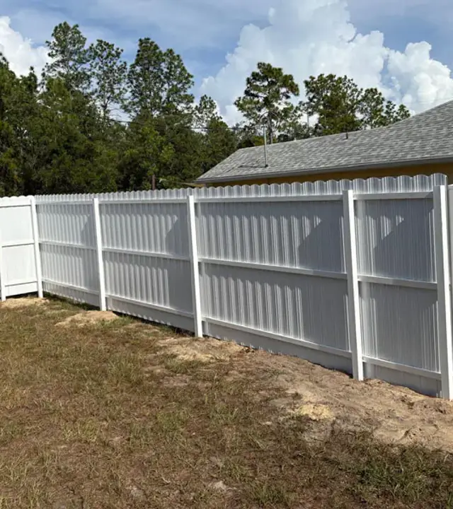 White Durafence steel privacy fence at a residential backyard corner