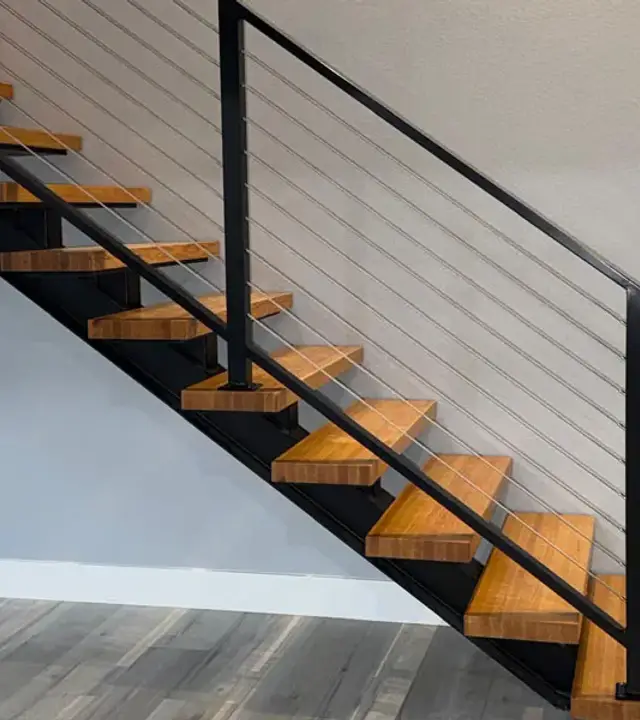 Black metal railing along a modern indoor staircase