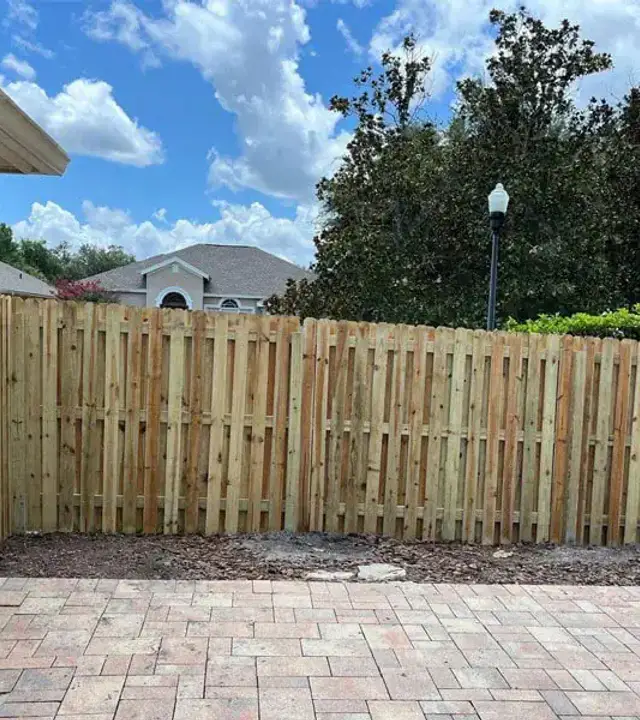 Completed wood privacy fence beside a residential patio