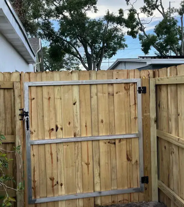 Custom wood access gate in a privacy fence